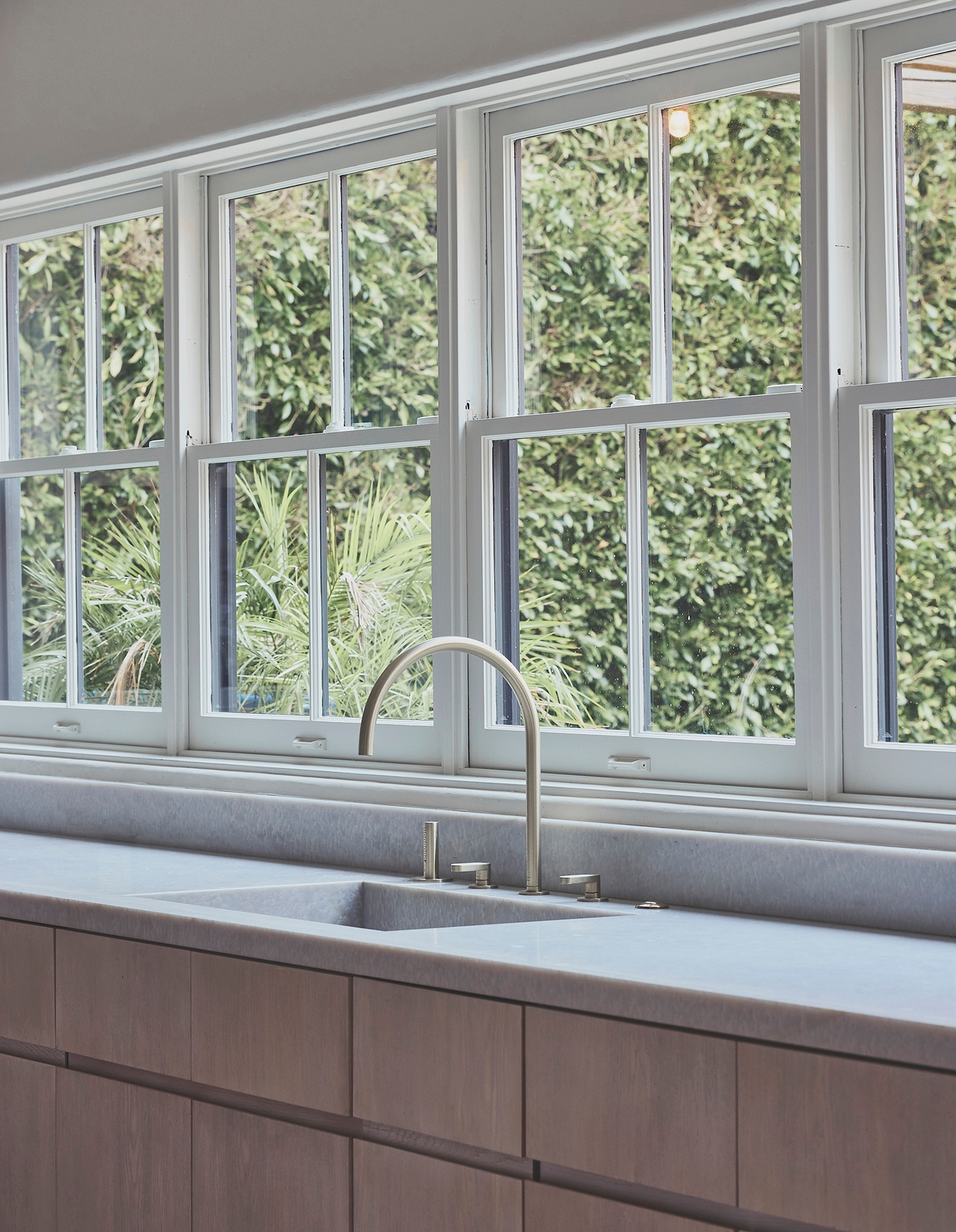 a kitchen with a sink and a lot of windows