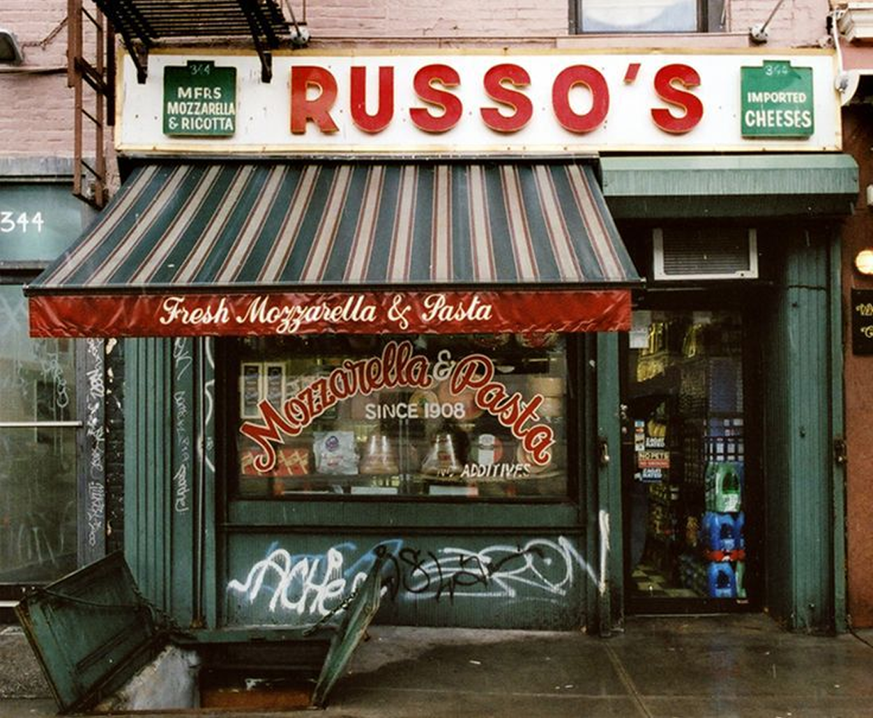 Russo's, an old Italian deli with striped awnings and graffiti on its storefront.
