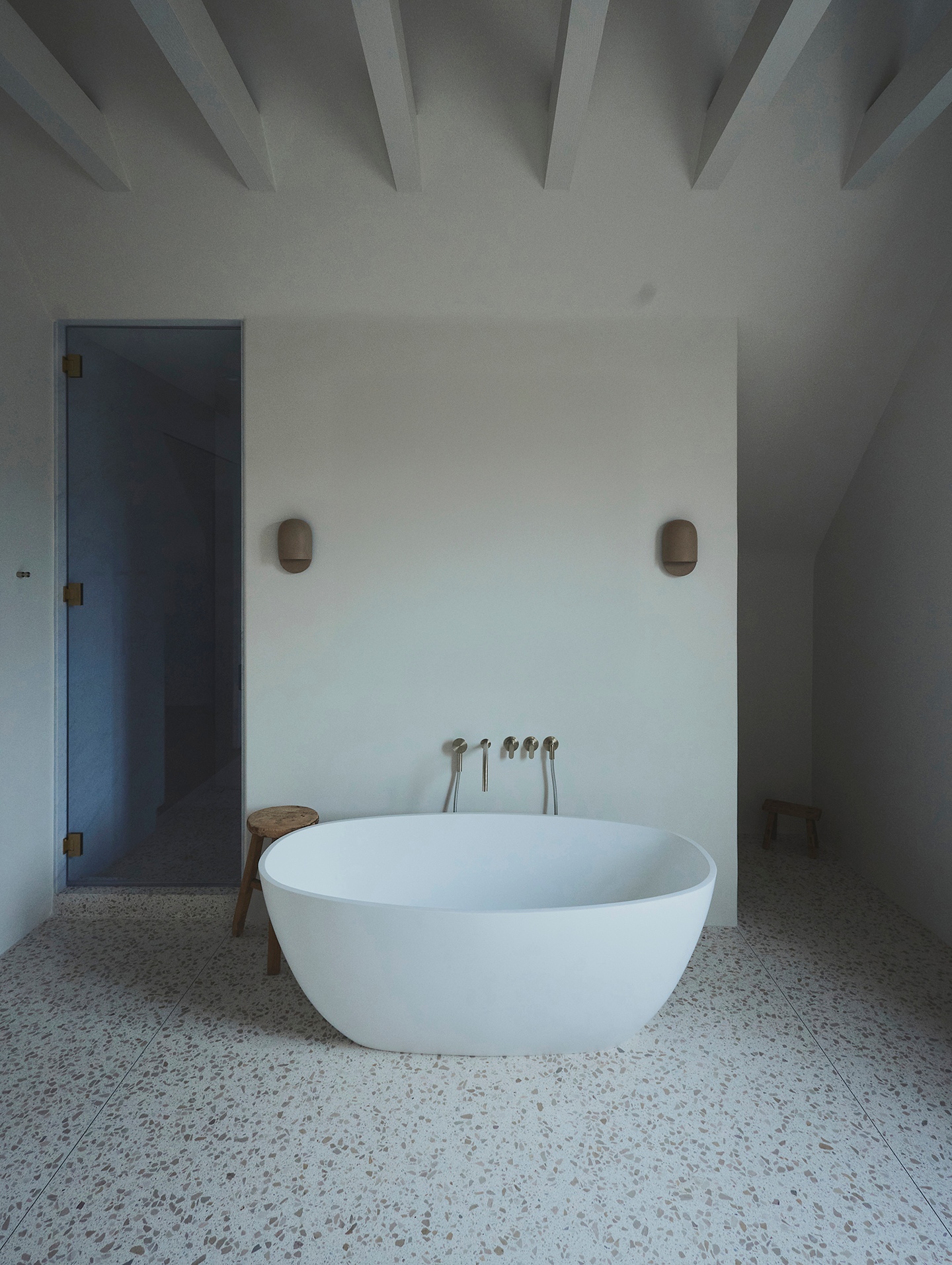 a bathroom with a bathtub and a stool