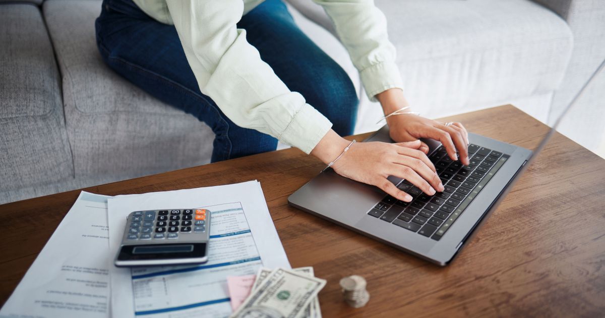 woman works with laptop calculator and money