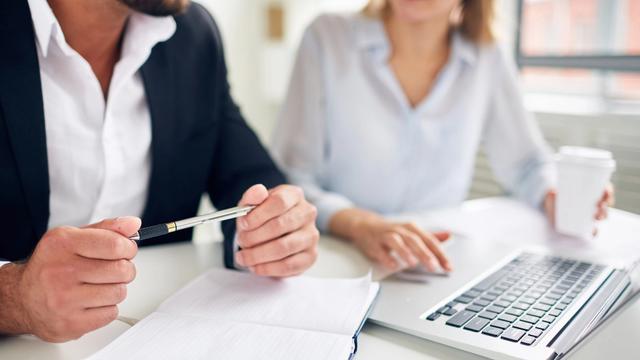 Two people sitting at computer
