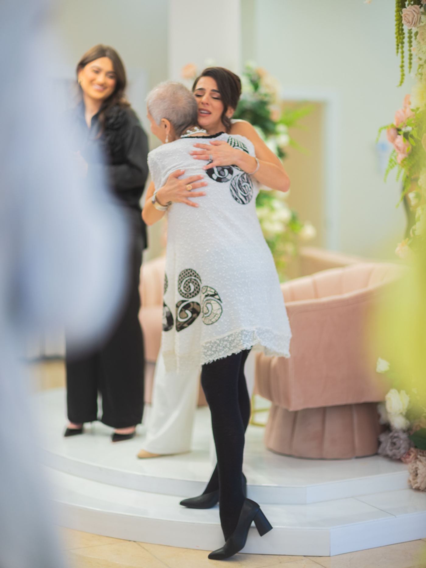 Renée Marino embracing an attendee after an event