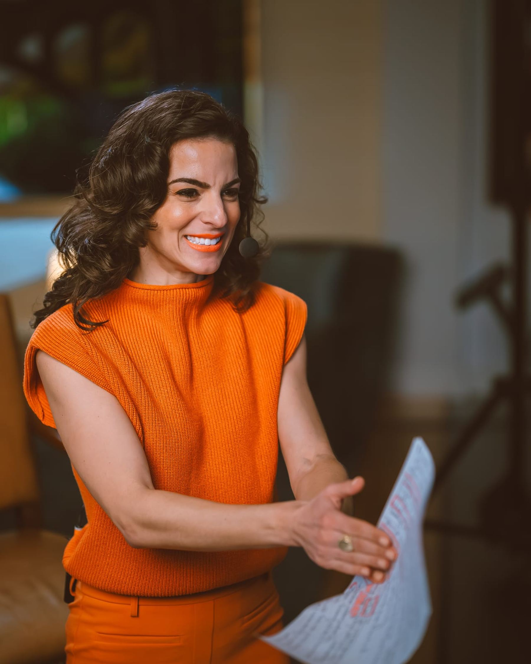 Renée Marino hosting with headset and run of show