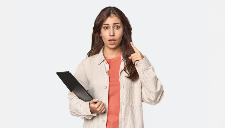 How to Check EAD Status: Quick and Easy Steps | Immiva Surprised woman holding a tablet, pointing upwards as if she just realized something important, illustrating the process of checking EAD status.