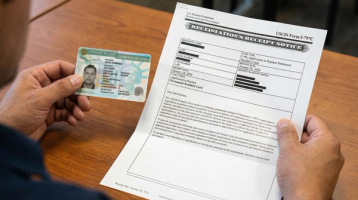 Person Holding Expired Green Card and Renewal Documents | Immiva