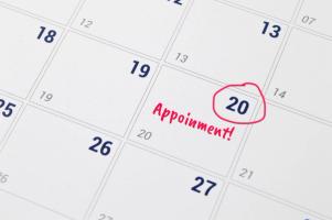 Calendar and USCIS appointment notice showing a rescheduled biometrics appointment date, illustrating how to reschedule or postpone a USCIS biometrics appointment