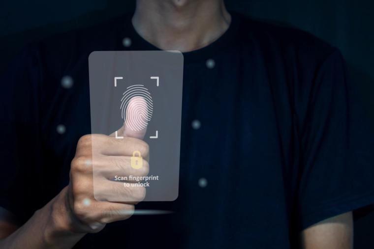 N-400 Biometrics Fingerprint Scan Security Verification | Immiva Person scanning their thumbprint on a transparent biometric security interface, representing the USCIS N-400 biometrics appointment fingerprint capture