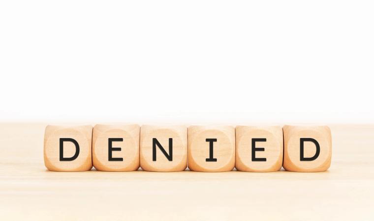 H-4 EAD Denied Wooden Block Letters on Desk | Immiva Wooden block letters spelling DENIED on a light wooden surface, representing H-4 EAD denial reasons and how to respond to USCIS refusals