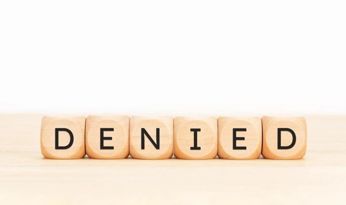 H-4 EAD Denied Wooden Block Letters on Desk | Immiva Wooden block letters spelling DENIED on a light wooden surface, representing H-4 EAD denial reasons and how to respond to USCIS refusals