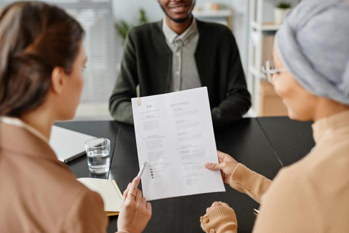 Hiring Managers Reviewing Candidate’s CV During Job Interview