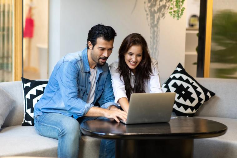 Illustration of H-4 Visa Holder Using Immiva to Apply for EAD | Immiva Person on H-4 visa using a laptop to apply for an EAD through Immiva, with a simplified checklist and approved work permit shown on screen