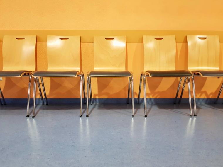 Waiting area at a USCIS Application Support Center for a biometrics appointment | Immiva Empty chairs in the waiting area of a USCIS Application Support Center where applicants wait for their biometrics appointment fingerprinting and photo