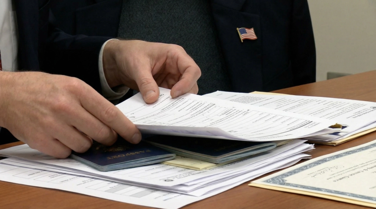 Preparing N-400 Documents for Citizenship Application | Immiva Person organizing N-400 documents needed for U.S. citizenship application including Green Card copies and tax records