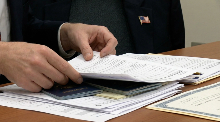 Preparing N-400 Documents for Citizenship Application | Immiva Person organizing N-400 documents needed for U.S. citizenship application including Green Card copies and tax records