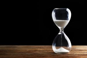 August 2026 Visa Bulletin | Immiva Hourglass with sand running out, representing August 2026 visa bulletin priority date cutoffs and green card wait times