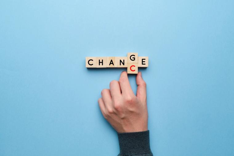 Changing to an H4 Visa Status Made Simple with Form I-539 | Immiva Hand rearranging wooden letter tiles spelling CHANGE to represent changing visa status to H4 using Form I-539 with Immiva help