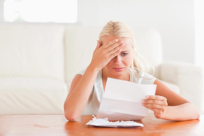 Avoiding Common H-4 EAD Application Mistakes | Immiva Worried woman holding her head while reading a letter, illustrating stress caused by H-4 EAD application mistakes – Immiva immigration assistance