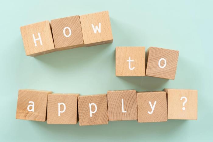 How to Fill Out Form I-539 in 2026 Step-by-Step Guide | Immiva Wooden blocks spelling out the question How to apply? on a light green background, illustrating a step-by-step guide to filling out Form I-539 in 2026.