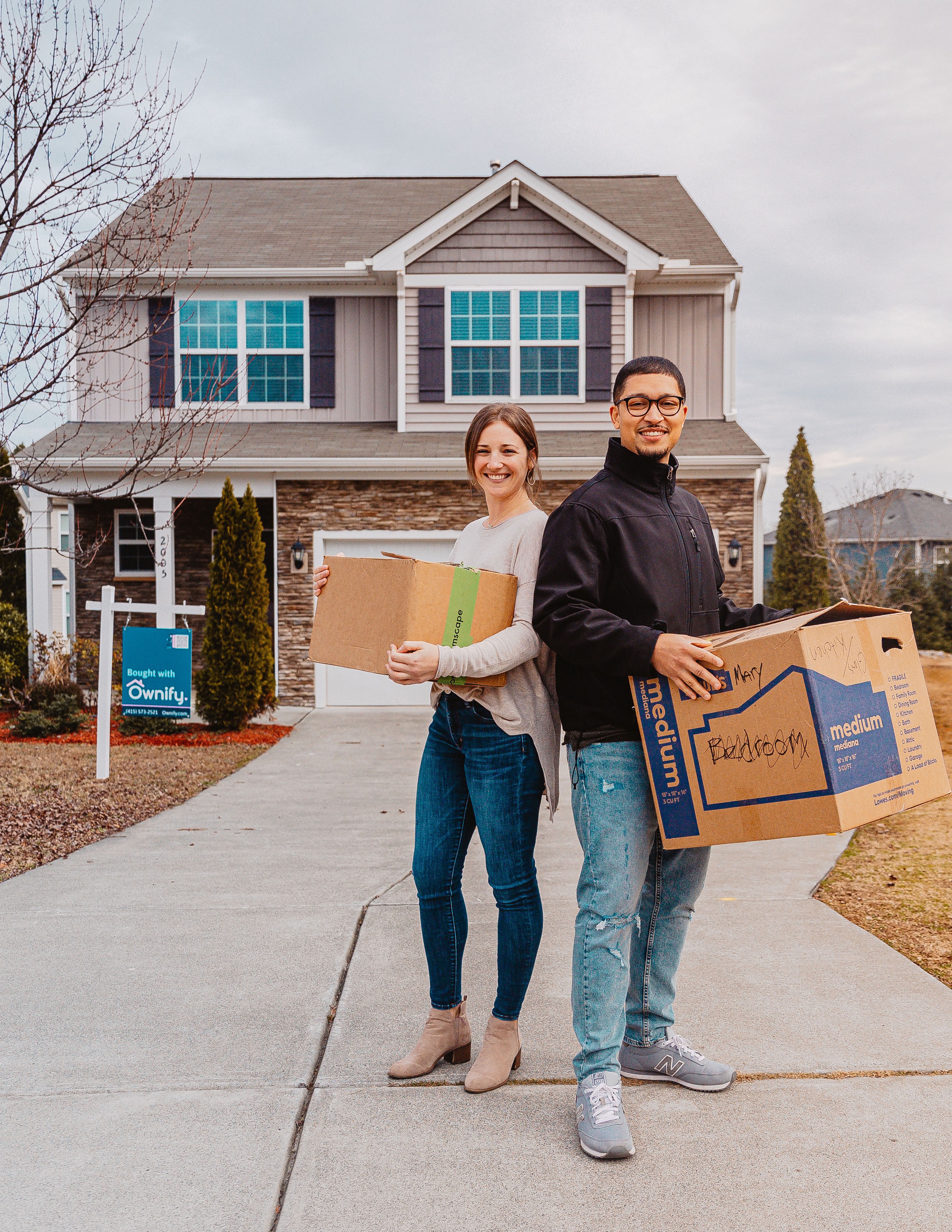 First-time fractional homebuyers Zac & Skylar in front of their new home in Raleigh