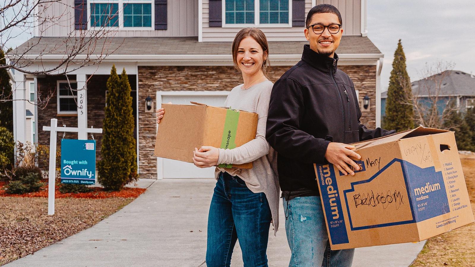 First-time fractional homebuyers Zac & Skylar in front of their new home in Raleigh