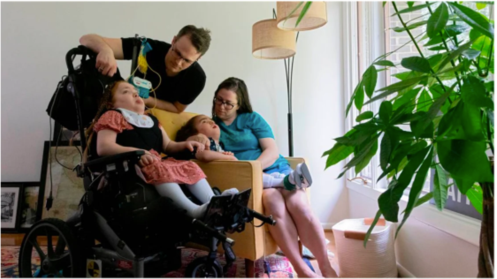 Jen, Evan, and their disabled children in their new home