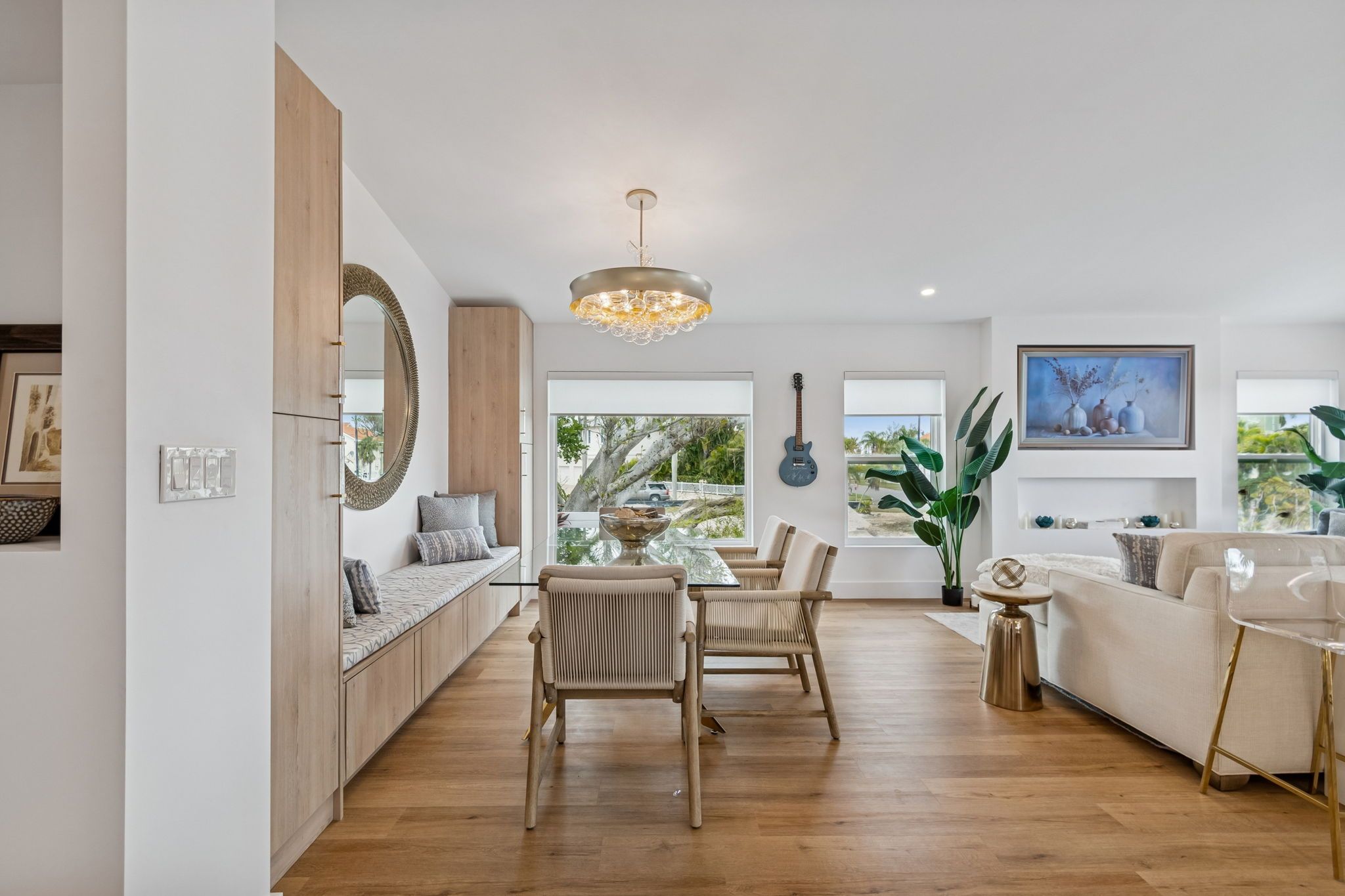 Open living and dining area with wood floors and wide windows — New home construction, Longboat Key