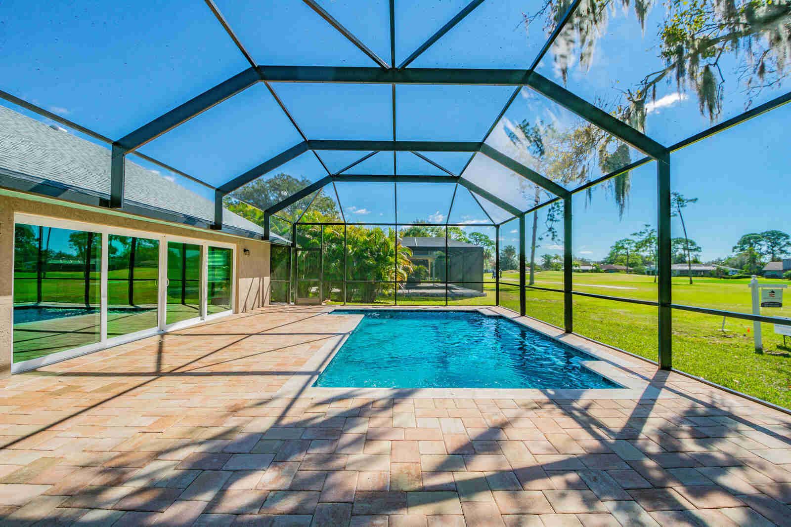 Screened pool with sliding glass doors — Custom home addition, pool, and renovation, Bradenton