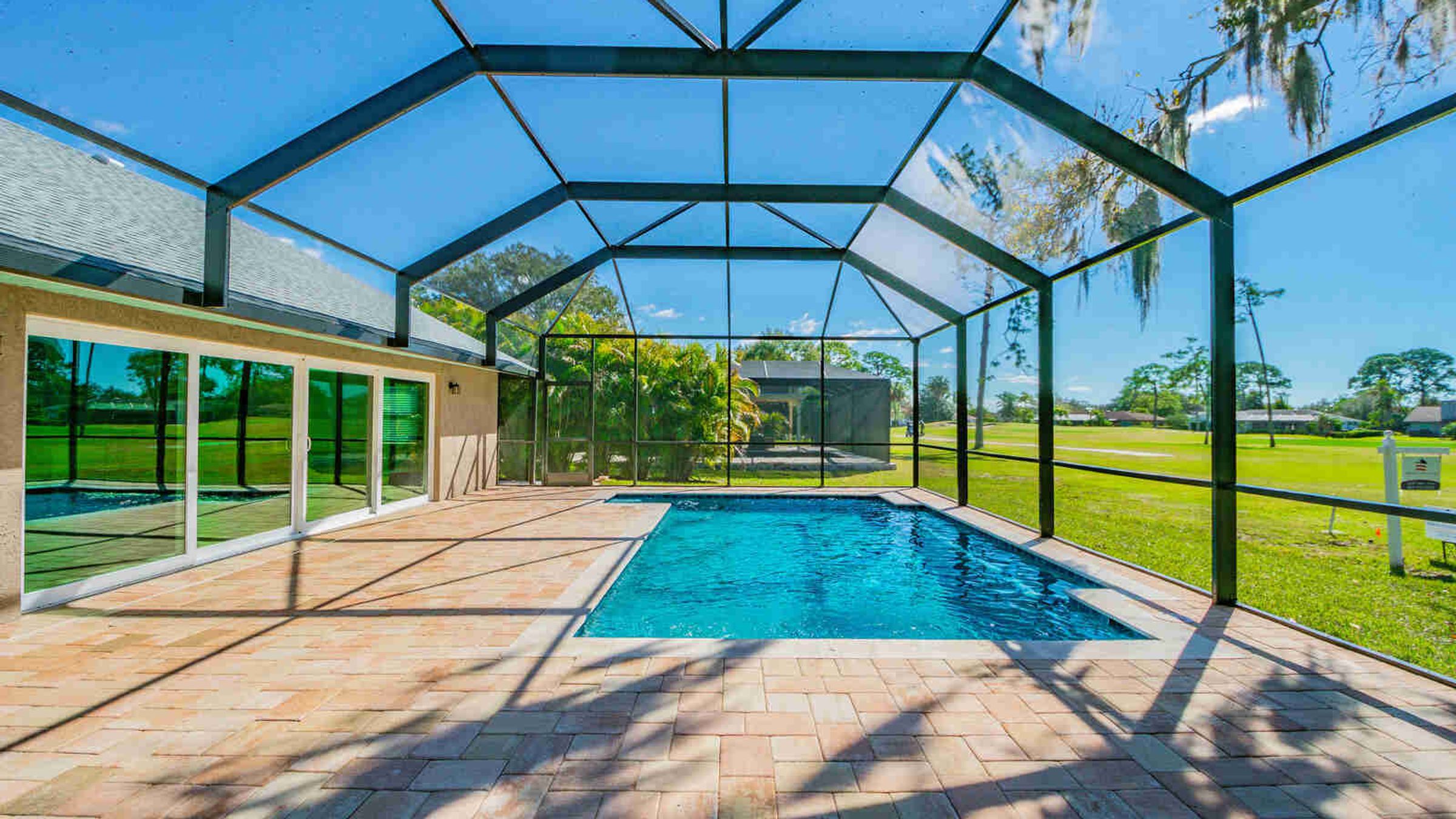 Screened pool with sliding glass doors — Custom home addition, pool, and renovation, Bradenton