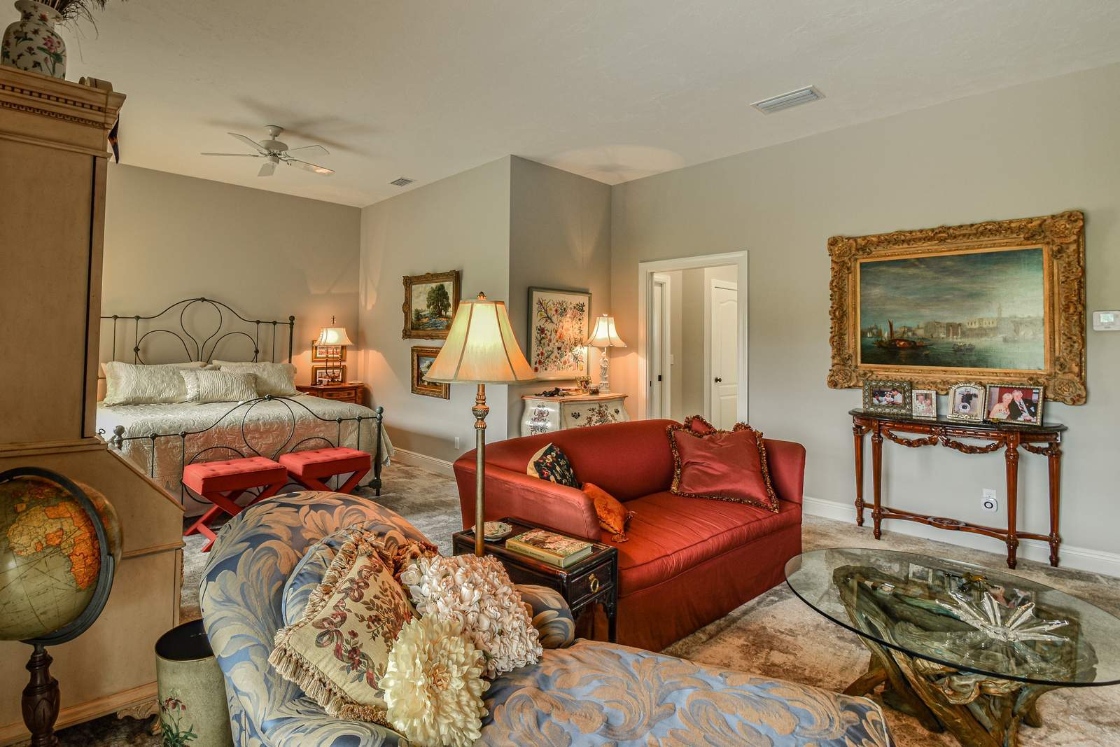 Primary bedroom red loveseat — Custom design-build near IMG Academy, West Bradenton
