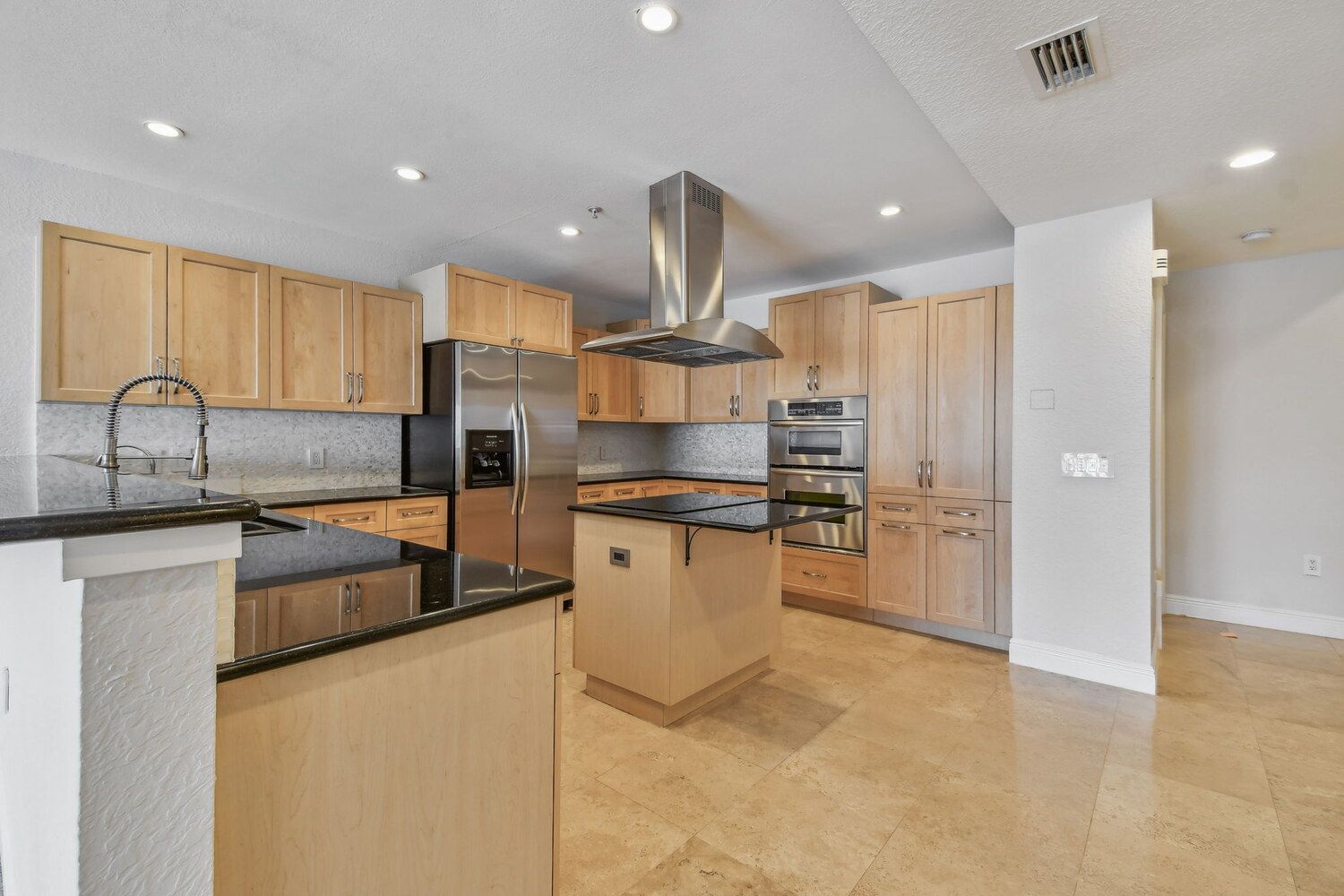 Open-concept kitchen featuring natural wood cabinetry — Waterfront condo renovation, Bradenton, FL