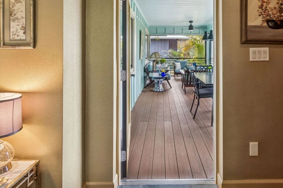 Interior hallway view through door to screened porch teal walls wood deck — Custom home addition, Longboat Key