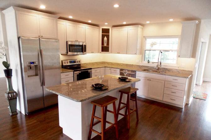 Custom kitchen with recessed lighting and granite island by Adkins Building &amp; Construction in Bradenton, FL