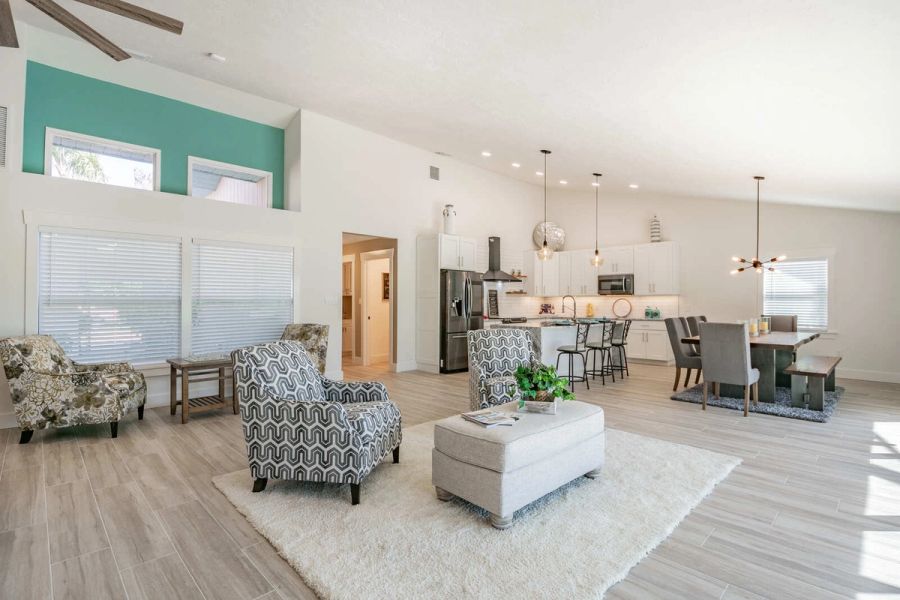 Living room with accent chairs and dining area — Custom home addition, pool, and renovation, Bradenton