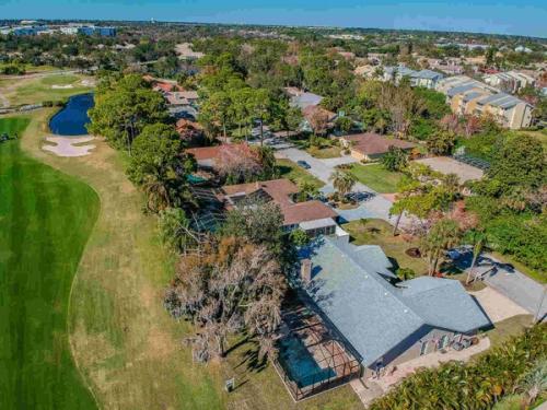 Aerial view of house golf course and pond — Custom home addition, pool, and renovation, Bradenton