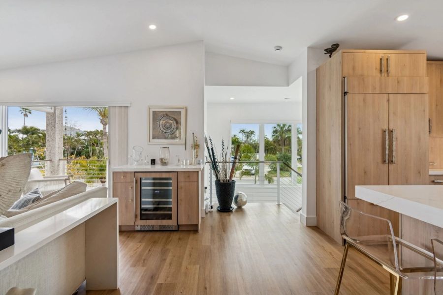 Interior living room wet bar wine cooler wood cabinetry balcony view — New home construction, Longboat Key