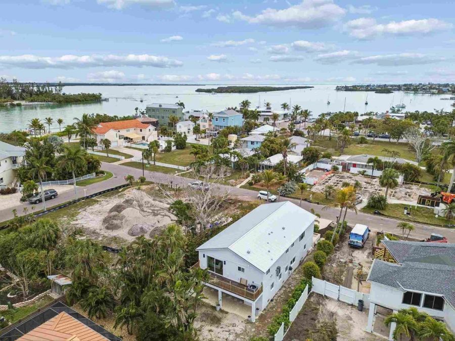 High aerial neighborhood waterway bay view — New home construction, Longboat Key
