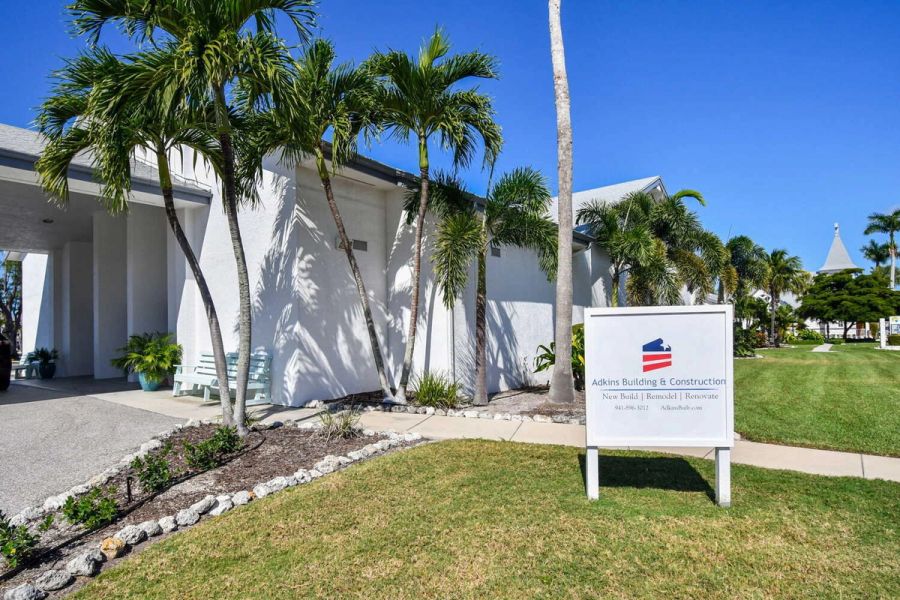 Exterior view of the project with palm trees and company sign — Roser Memorial Community Church, Anna Maria, FL