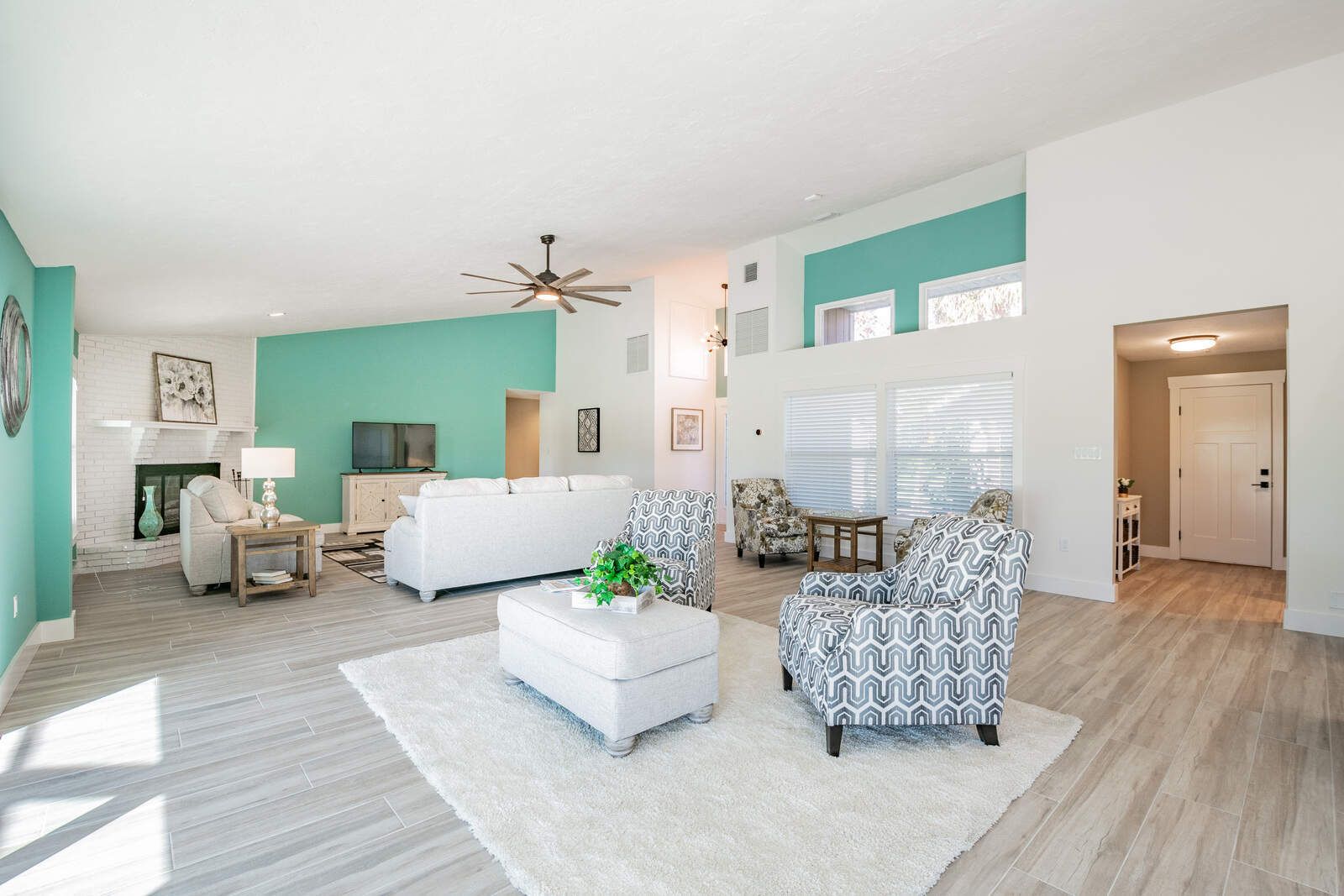 Living room with teal wall and fireplace — Custom home addition, pool, and renovation, Bradenton