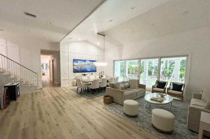 Living room with coastal decor and ocean views in a Holmes Beach custom home by Adkins Building & Construction