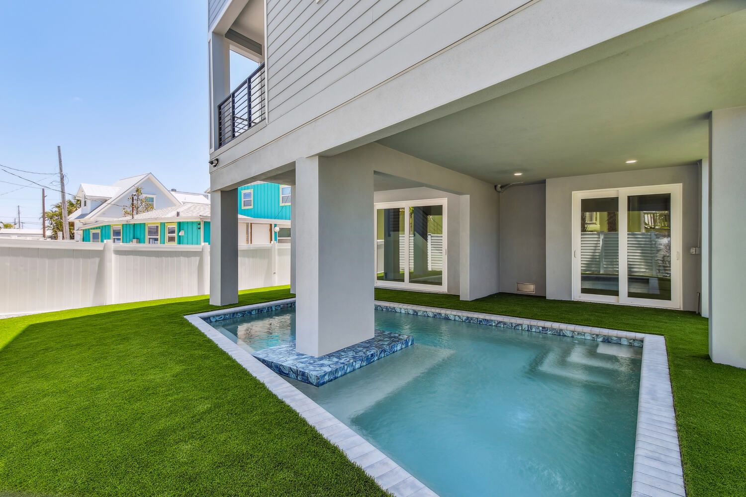 Elevated pool and green lawn — Coastal custom home, Bradenton Beach