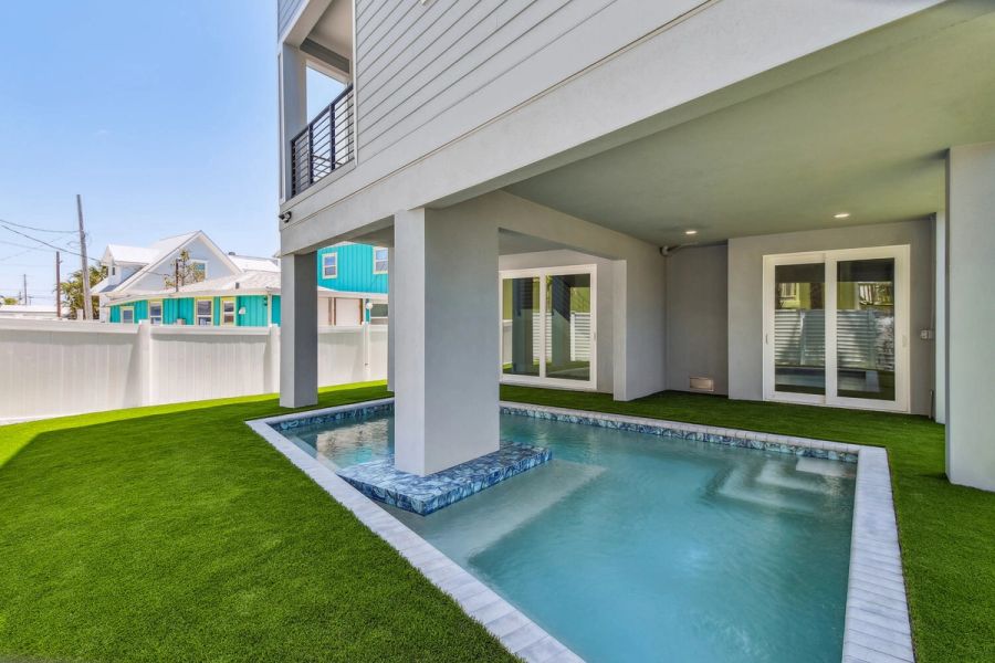 Elevated pool and green lawn — Coastal custom home, Bradenton Beach
