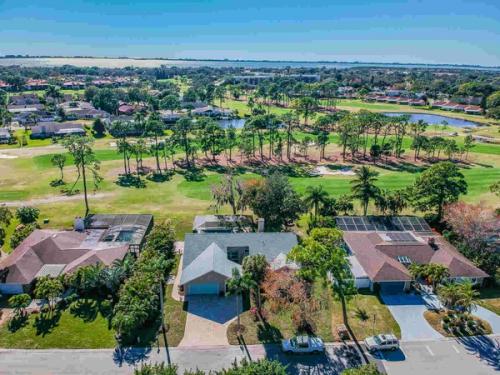 Aerial view of house with golf course and bay — Custom home addition, pool, and renovation, Bradenton