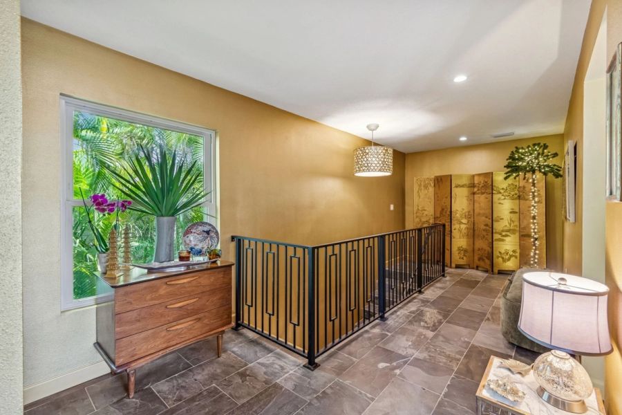 Interior upper hallway gold walls iron railing — Custom home addition, Longboat Key