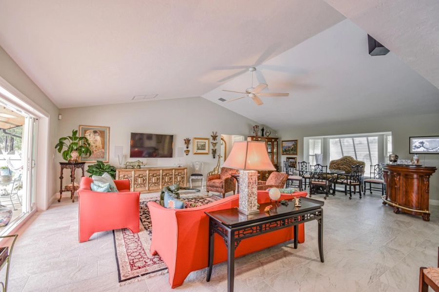 Living room orange sofas giraffe decor — Custom design-build near IMG Academy, West Bradenton