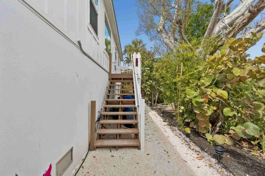 Exterior side staircase tropical landscaping — New home construction, Longboat Key