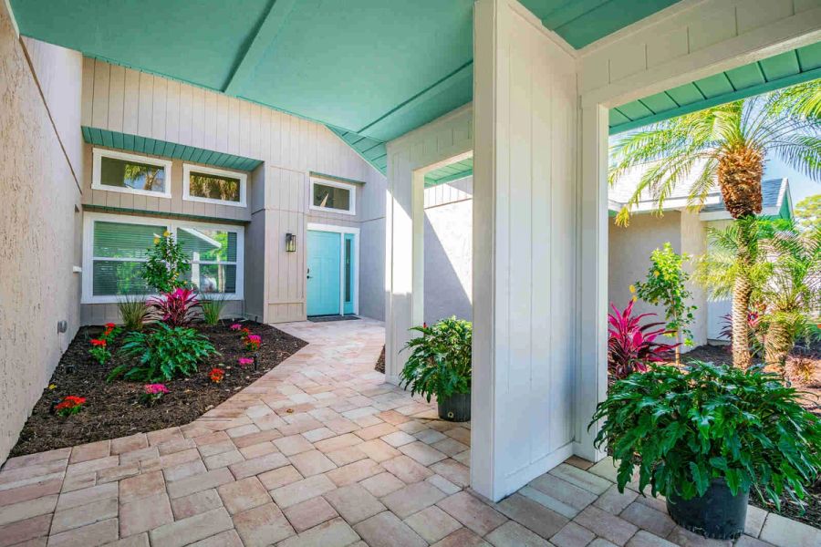 Courtyard entry with teal front door — Custom home addition, pool, and renovation, Bradenton