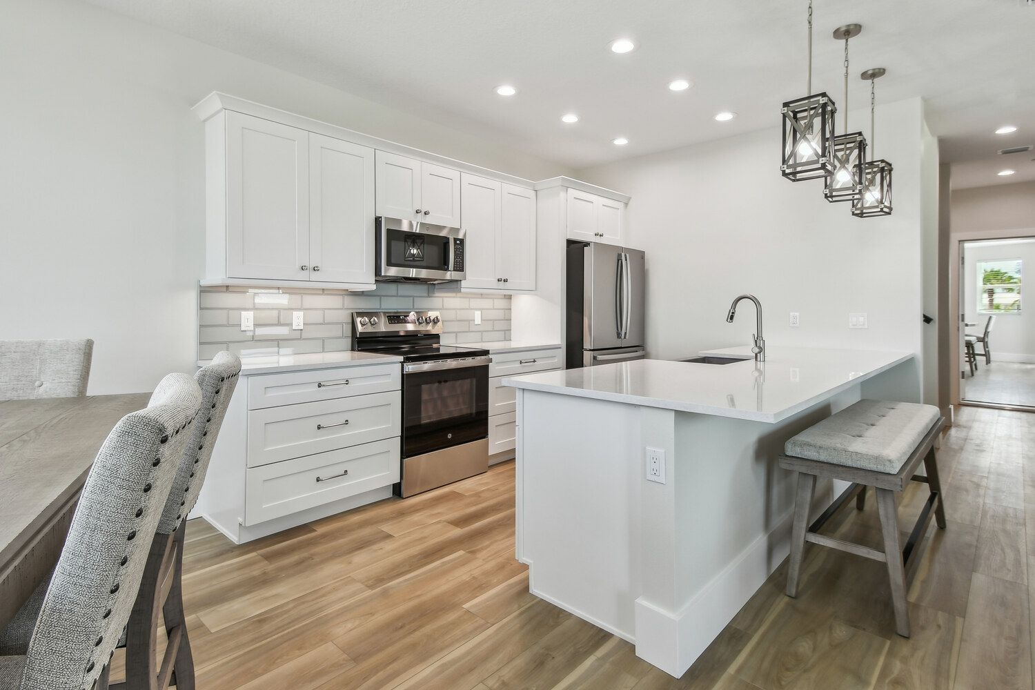 Modern white kitchen with island — Coastal custom home, Bradenton Beach