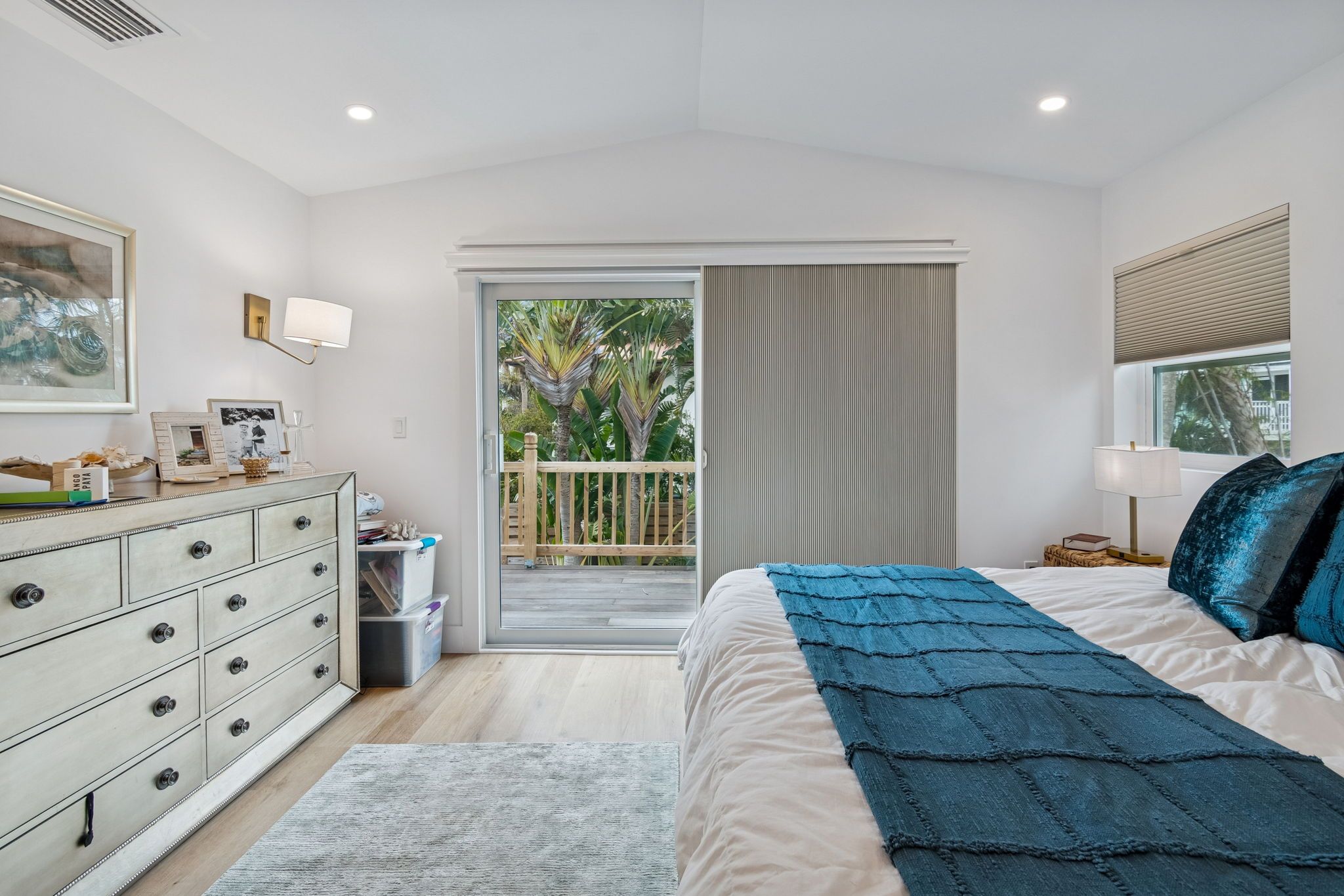 Bedroom with a white dresser and teal bedding — New home construction, Longboat Key
