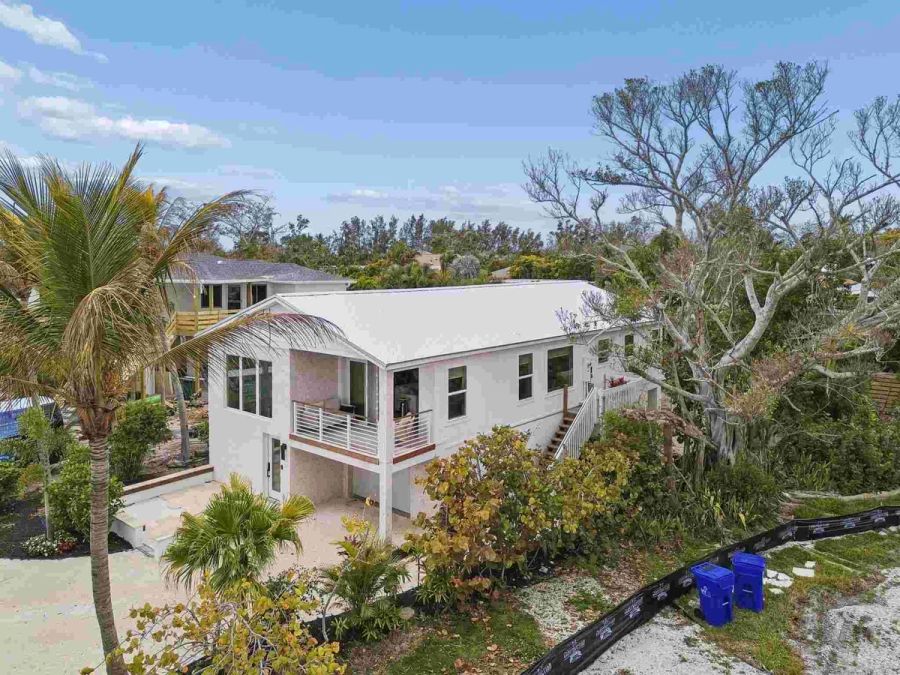 Aerial view white metal roof tropical trees — New home construction, Longboat Key