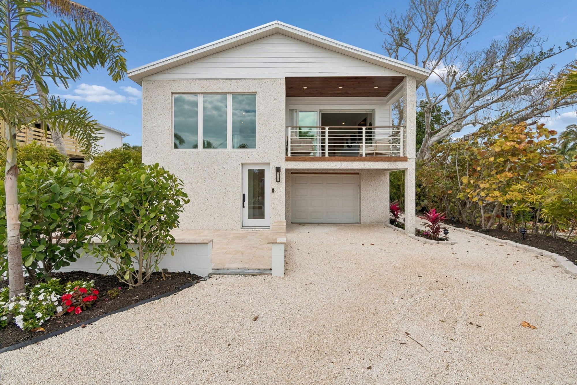 Coastal home exterior front entrance white stucco — New home construction, Longboat Key